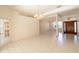 Bright, open living room with tile floors, large windows, and classic chandeliers, perfect for entertaining at 1586 Antoinette Ct, Oviedo, FL 32765