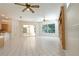 Open living room featuring white tile flooring, bright light and view to the back yard at 1586 Antoinette Ct, Oviedo, FL 32765