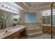 Bright main bathroom features a step-up soaking tub, dual vanities, and a glass-enclosed shower at 1586 Antoinette Ct, Oviedo, FL 32765