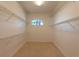 Spacious walk-in closet with carpeted floor, a window, and multiple levels of wire shelving at 1586 Antoinette Ct, Oviedo, FL 32765