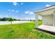 The backyard has luscious green grass and a view of the lake at 1596 Contentment Loop, Kissimmee, FL 34744