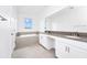 Modern bathroom featuring double sinks, quartz countertop, and gray tile flooring and backsplash at 1596 Contentment Loop, Kissimmee, FL 34744