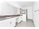 Bathroom features dual sinks, a glass shower, and gray tiled flooring at 1596 Contentment Loop, Kissimmee, FL 34744