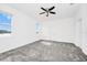Bright bedroom features a ceiling fan, plush carpet, and lake views from the large window at 1596 Contentment Loop, Kissimmee, FL 34744