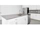 Kitchen island with gray countertop, stainless steel sink and appliances, and ample storage at 1596 Contentment Loop, Kissimmee, FL 34744