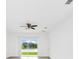 Living room with a view of the backyard and ceiling fan at 1596 Contentment Loop, Kissimmee, FL 34744