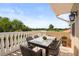 Serene balcony view overlooking the golf course and lush greenery with outdoor dining set at 1705 Saint Tropez Ct, Kissimmee, FL 34744