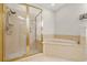 Well-maintained bathroom featuring a shower and a tub, with gold trim and fixtures at 1705 Saint Tropez Ct, Kissimmee, FL 34744