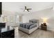 Well-lit bedroom with ceiling fan, a bed with striped bedding, and access to the outside through glass doors at 1705 Saint Tropez Ct, Kissimmee, FL 34744