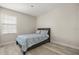 Cozy bedroom with wood floors, a bed with blue patterned bedding, and a bright window at 1705 Saint Tropez Ct, Kissimmee, FL 34744