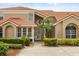 Inviting front exterior of home featuring a red tile roof, stucco facade, and lush landscaping at 1705 Saint Tropez Ct, Kissimmee, FL 34744