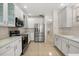 Spacious kitchen with stainless steel appliances, white cabinets, and plenty of counter space at 1705 Saint Tropez Ct, Kissimmee, FL 34744
