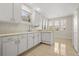 Bright kitchen featuring white cabinetry, tile floors, and a breakfast nook with natural light at 1705 Saint Tropez Ct, Kissimmee, FL 34744