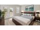 Comfortable main bedroom featuring a king bed, balcony access, and stylish decor at 1705 Saint Tropez Ct, Kissimmee, FL 34744