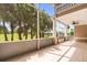 Spacious screened-in patio with tile flooring, a ceiling fan, and views of the surrounding golf course at 1705 Saint Tropez Ct, Kissimmee, FL 34744