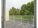 Outdoor balcony featuring tiled flooring, white railings and views of mature trees at 17516 Blessing Dr, Clermont, FL 34714