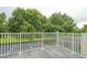 Outdoor balcony featuring tiled flooring, white railings and views of mature trees at 17516 Blessing Dr, Clermont, FL 34714