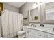 Well lit bathroom with updated cabinetry, framed mirrors, and tiled backsplash at 17516 Blessing Dr, Clermont, FL 34714