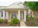 Home featuring covered front porch, brick walkway and mature landscaping at 17516 Blessing Dr, Clermont, FL 34714