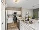 Modern kitchen with stainless steel appliances, white cabinets, and granite countertops at 17516 Blessing Dr, Clermont, FL 34714
