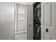 Convenient in-unit, stacked washer and dryer, framed by a door, offering a practical laundry solution at 17516 Blessing Dr, Clermont, FL 34714