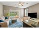 Bright and airy living room with a view of the pool, modern furniture, and stylish decor at 17516 Blessing Dr, Clermont, FL 34714