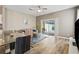 Open living space with sliding glass doors leading to the pool, modern furnishings, and light wood floors at 17516 Blessing Dr, Clermont, FL 34714