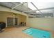 Private, covered patio with a refreshing swimming pool, brick pavers, and comfortable seating at 17516 Blessing Dr, Clermont, FL 34714