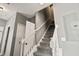 Carpeted stairway featuring white railings, leading to the upper level of the home; neutral gray walls add modern look at 17516 Blessing Dr, Clermont, FL 34714