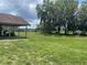 Expansive backyard with lush lawn and mature trees, offering privacy and space at 17952 Lookout Hill Rd, Winter Garden, FL 34787
