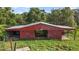 Well-maintained red barn with multiple stalls, providing excellent space for horses or other animals at 17952 Lookout Hill Rd, Winter Garden, FL 34787