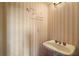 Charming half-bathroom with pedestal sink and wall decor at 17952 Lookout Hill Rd, Winter Garden, FL 34787