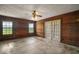 Bedroom showcasing wood-paneled walls, a ceiling fan, and sliding glass doors at 17952 Lookout Hill Rd, Winter Garden, FL 34787