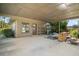 Spacious carport featuring ample room for parking with exterior door and adjacent lawn at 17952 Lookout Hill Rd, Winter Garden, FL 34787