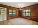 Dining room featuring wood-paneled walls and large windows at 17952 Lookout Hill Rd, Winter Garden, FL 34787