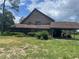 Charming two-story home with a carport and front yard showcasing potential at 17952 Lookout Hill Rd, Winter Garden, FL 34787