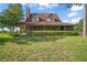 Inviting home with a covered porch, screen porch, complemented by a well-manicured lawn and mature trees at 17952 Lookout Hill Rd, Winter Garden, FL 34787