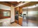 Kitchen view featuring stainless steel appliances, wooden cabinetry, and tile flooring at 17952 Lookout Hill Rd, Winter Garden, FL 34787