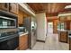Kitchen view featuring stainless steel appliances, wooden cabinetry, and tile flooring at 17952 Lookout Hill Rd, Winter Garden, FL 34787
