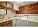 Laundry room with washer and dryer, sink, and wood paneling at 17952 Lookout Hill Rd, Winter Garden, FL 34787