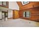 Spacious living room featuring unique wood paneling, large windows, and plenty of natural light at 17952 Lookout Hill Rd, Winter Garden, FL 34787