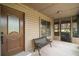 Inviting covered porch with a bench and screened windows, providing a comfortable outdoor space at 17952 Lookout Hill Rd, Winter Garden, FL 34787