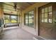 View of the screened-in porch, complete with a cozy swing, wood ceiling with fan and a window view of green trees at 17952 Lookout Hill Rd, Winter Garden, FL 34787