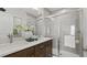 Modern bathroom featuring dual sinks, sleek countertops, and a glass-enclosed shower with tile surround at 1916 Diamond Head Cir, Lake Hamilton, FL 33851