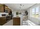 Well-lit kitchen featuring stainless steel appliances and a central island with bar stool seating at 1916 Diamond Head Cir, Lake Hamilton, FL 33851