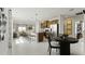Open-concept kitchen and living area with a large island, stainless steel appliances, and modern pendant lighting at 1916 Diamond Head Cir, Lake Hamilton, FL 33851