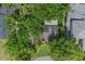 Birds-eye view of a home surrounded by mature trees, a green lawn, and neighboring houses at 1961 Winter Park Rd, Winter Park, FL 32789