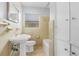 Full bathroom featuring vintage-style sink and toilet with tiled shower/bath at 1961 Winter Park Rd, Winter Park, FL 32789