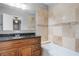 Bathroom with a wood vanity, granite countertop, and tiled bathtub with showerhead at 1961 Winter Park Rd, Winter Park, FL 32789
