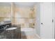 Full bathroom featuring tiled bathtub and shower, with dark countertop and white door at 1961 Winter Park Rd, Winter Park, FL 32789